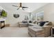 Spacious living room with L-shaped sectional sofa, fireplace and built-in shelving at 5149 S Malta Way, Centennial, CO 80015