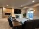 Finished basement features a stone fireplace, large screen tv, and sliding glass door leading to the backyard at 7758 Edgewater Ct, Lone Tree, CO 80124