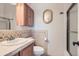 Bathroom features a modern vanity with granite counters, wood cabinet and frameless glass shower doors at 7758 Edgewater Ct, Lone Tree, CO 80124