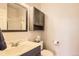 Bathroom featuring a modern vanity with white sink and dark cabinets at 7758 Edgewater Ct, Lone Tree, CO 80124