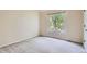 Bedroom with neutral carpet, light walls and a window overlooking a wooded yard at 7758 Edgewater Ct, Lone Tree, CO 80124