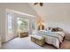 Vaulted bedroom with large bright windows, wicker accents and comfy furnishings at 7758 Edgewater Ct, Lone Tree, CO 80124