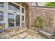 Stone patio leading to the front door with transom windows and brick facade at 7758 Edgewater Ct, Lone Tree, CO 80124