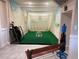 Golf simulator room in a home features a putting green, golf clubs and putting accessories at 7758 Edgewater Ct, Lone Tree, CO 80124
