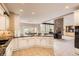 Open kitchen with granite countertops, white cabinetry, and seamless flow to the living area at 7758 Edgewater Ct, Lone Tree, CO 80124
