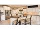 Spacious kitchen with granite countertops and breakfast bar with stools, perfect for casual dining at 7758 Edgewater Ct, Lone Tree, CO 80124