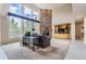 Bright living room boasts soaring ceilings, large windows, and a striking brick fireplace at 7758 Edgewater Ct, Lone Tree, CO 80124