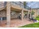 Covered patio with brick columns, outdoor seating, and a hot tub in the backyard at 7758 Edgewater Ct, Lone Tree, CO 80124