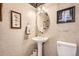 Charming powder room features stylish wallpaper, pedestal sink, and elegant framed artwork at 7758 Edgewater Ct, Lone Tree, CO 80124