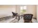 Bright sitting room with floor to ceiling windows that boast an outdoor view and decorative rattan furniture at 7758 Edgewater Ct, Lone Tree, CO 80124