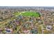 An aerial view of the neighborhood with lush green trees and a park in the distance at 371 Birch St, Denver, CO 80220