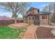 Exterior of a home featuring a balcony and a large brick patio at 371 Birch St, Denver, CO 80220