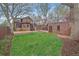 Exterior of a home featuring a balcony, grass, brick patio, and a detached garage at 371 Birch St, Denver, CO 80220