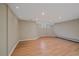Finished basement with hardwood floors, bright recessed lighting, and a small window at 371 Birch St, Denver, CO 80220