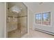 Bathroom boasts a glass-enclosed shower, natural light, and neutral tile finishes at 371 Birch St, Denver, CO 80220