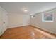 Simple bedroom featuring hardwood floors, two windows and freshly painted walls at 371 Birch St, Denver, CO 80220