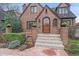 Charming brick home with a beautiful arched front door and well-maintained landscaping at 371 Birch St, Denver, CO 80220