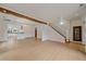 Open-concept living area with hardwood floors leading to kitchen and staircase at 371 Birch St, Denver, CO 80220