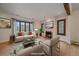 Bright living room with hardwood floors, fireplace, and large windows offering natural light at 371 Birch St, Denver, CO 80220