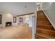 Bright living room with hardwood floors, fireplace, and a staircase at 371 Birch St, Denver, CO 80220