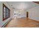 Bright living space leading into kitchen area, featuring hardwood floors and bright window at 371 Birch St, Denver, CO 80220