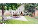 Backyard featuring stone patio, green space, and outdoor dining at 1266 N Pearl St, Denver, CO 80203