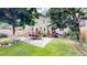 Spacious backyard featuring a lush lawn, a patio with outdoor furniture, and mature trees providing ample shade at 1266 N Pearl St, Denver, CO 80203