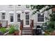 Backyard view of a white brick home with a small deck and lush garden at 1266 N Pearl St, Denver, CO 80203