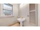 Compact bathroom featuring a pedestal sink and window view at 1266 N Pearl St, Denver, CO 80203