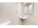 Quaint powder room featuring a small sink, mirror, and toilet at 1266 N Pearl St, Denver, CO 80203
