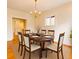 Charming dining room with hardwood floors, gold chandelier, and seating for six at 1266 N Pearl St, Denver, CO 80203