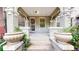 Inviting front porch featuring classic brickwork, decorative pillars, and potted plants, adding to the home's curb appeal at 1266 N Pearl St, Denver, CO 80203