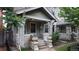 Charming brick front porch with decorative pillars and ornate flower pots, offering a cozy and inviting entryway at 1266 N Pearl St, Denver, CO 80203
