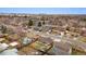 Aerial view of the neighborhood, showcasing the surrounding homes and tree-lined streets under a bright sky at 1667 S Balsam Ct, Lakewood, CO 80232