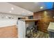 Stylish basement bar features wood accent wall and seating, perfect for entertaining at 1667 S Balsam Ct, Lakewood, CO 80232