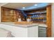 Finished basement bar featuring wood paneling, concrete counter, and soft LED lighting at 1667 S Balsam Ct, Lakewood, CO 80232