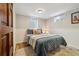 Bedroom featuring updated fixtures, wood floors and a window at 1667 S Balsam Ct, Lakewood, CO 80232