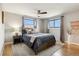 Comfortable bedroom with a ceiling fan, natural light, and neutral color palette at 1667 S Balsam Ct, Lakewood, CO 80232