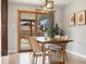 Dining area featuring hardwood floors, modern lighting, and a sliding glass door to the backyard at 1667 S Balsam Ct, Lakewood, CO 80232