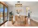 Cozy dining room with hardwood floors, a modern light fixture, and a sliding glass door to the backyard at 1667 S Balsam Ct, Lakewood, CO 80232