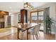 Bright dining area with hardwood floors, modern lighting, and backyard access at 1667 S Balsam Ct, Lakewood, CO 80232