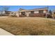 Inviting single-story home with a brick facade, attached garage, well-maintained lawn, and welcoming entryway at 1667 S Balsam Ct, Lakewood, CO 80232