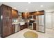 Well-equipped kitchen with stainless steel appliances, custom cabinets, and patterned backsplash at 1667 S Balsam Ct, Lakewood, CO 80232