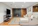 Cozy basement living room featuring a fireplace with wood and brick accents at 1667 S Balsam Ct, Lakewood, CO 80232