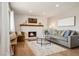 Inviting living room featuring a cozy fireplace, hardwood floors, and ample natural light at 1667 S Balsam Ct, Lakewood, CO 80232