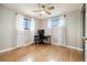 Home office with a modern desk, natural light, and hardwood floors at 1667 S Balsam Ct, Lakewood, CO 80232