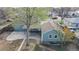 Aerial view of the home and surrounding neighborhood featuring a detached garage and fenced yard at 415 S Parfet St, Lakewood, CO 80226