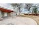 View of backyard featuring mature trees, and a spacious patio and storage sheds at 415 S Parfet St, Lakewood, CO 80226