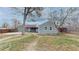 Expansive backyard view with privacy fencing, mature trees, and access to the home and garage at 415 S Parfet St, Lakewood, CO 80226