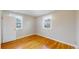 Bright bedroom with hardwood floors and two windows offering natural light at 415 S Parfet St, Lakewood, CO 80226
